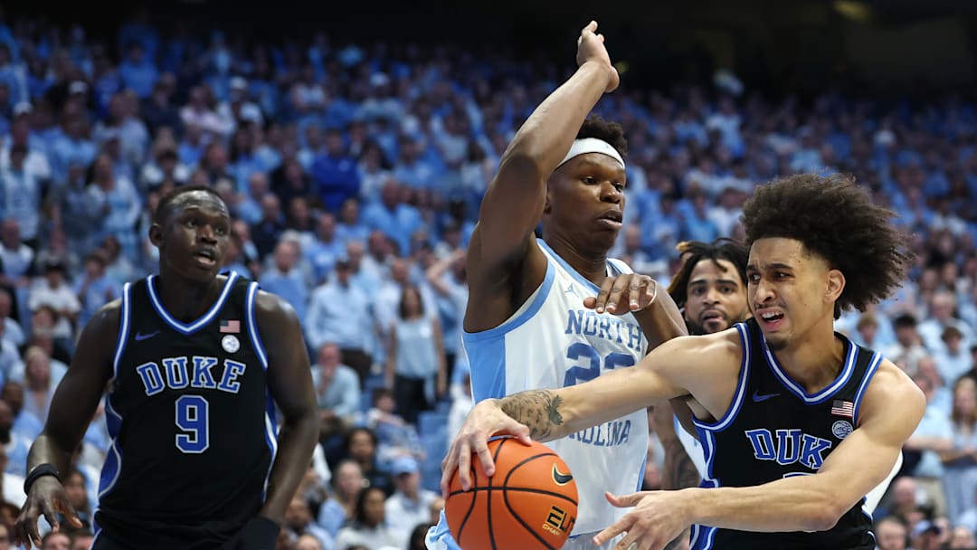 Duke v North Carolina; Duke basketball guard passes around UNC center Ven-Allen Lubin