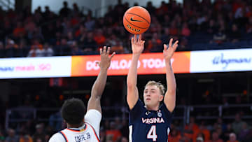 Mar 8, 2025; Syracuse, New York, USA; Virginia Cavaliers guard Andrew Rohde (4) shoots against Syracuse Orange guard Kyle Cuffe Jr. (0) during the second half at the JMA Wireless Dome. Mandatory Credit: Rich Barnes-Imagn Images