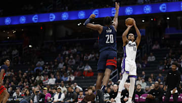 Apr 2, 2025; Washington, District of Columbia, USA; Sacramento Kings forward Keegan Murray (13) shoots the ball as Washington Wizards forward Alex Sarr (20) in the first half at Capital One Arena. Mandatory Credit: Geoff Burke-Imagn Images