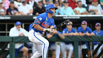 Jun 19, 2024; Omaha, NE, USA;  Florida Gators shortstop Colby Shelton (10) doubles against the Texas A&M Aggies during the second inning at Charles Schwab Field Omaha. Mandatory Credit: Steven Branscombe-Imagn Images