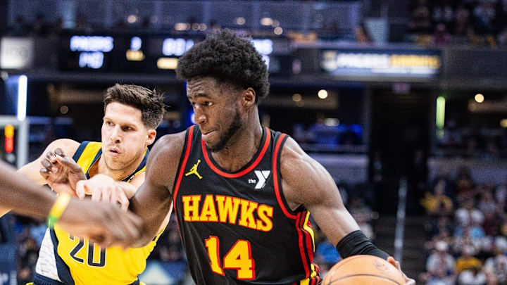 Apr 14, 2024; Indianapolis, Indiana, USA; Atlanta Hawks forward AJ Griffin (14) dribbles the ball while Indiana Pacers forward Doug McDermott (20) defends in the second half at Gainbridge Fieldhouse. Mandatory Credit: Trevor Ruszkowski-Imagn Images