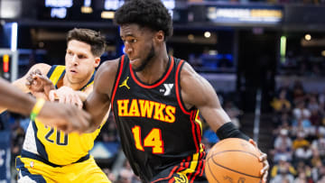 Apr 14, 2024; Indianapolis, Indiana, USA; Atlanta Hawks forward AJ Griffin (14) dribbles the ball while Indiana Pacers forward Doug McDermott (20) defends in the second half at Gainbridge Fieldhouse. Mandatory Credit: Trevor Ruszkowski-USA TODAY Sports