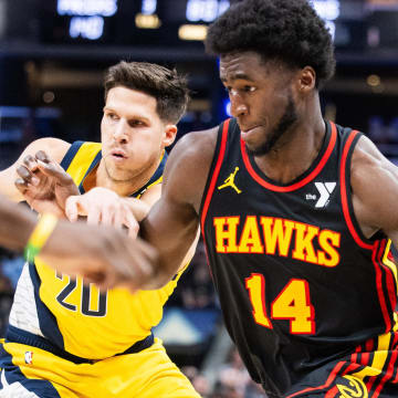 Apr 14, 2024; Indianapolis, Indiana, USA; Atlanta Hawks forward AJ Griffin (14) dribbles the ball while Indiana Pacers forward Doug McDermott (20) defends in the second half at Gainbridge Fieldhouse. Mandatory Credit: Trevor Ruszkowski-USA TODAY Sports