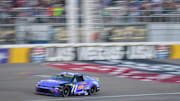 Oct 12, 2025; Las Vegas, Nevada, USA; NASCAR Cup Series driver Denny Hamlin (11) crosses the finish line to win the South Point 400 at Las Vegas Motor Speedway.