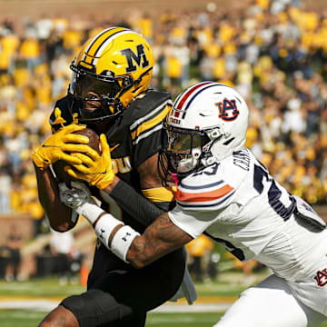 Oct 19, 2024; Columbia, Missouri, USA; Missouri Tigers wide receiver Theo Wease Jr. (1) runs with the ball against Auburn Tigers cornerback Jay Crawford (23) during the second half at Faurot Field at Memorial Stadium. Mandatory Credit: Jay Biggerstaff-Imagn Images
