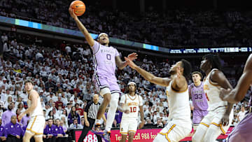 Feb 1, 2025; Ames, Iowa, USA; Kansas State Wildcats guard Dug McDaniel (0) splits the Iowa State Cyclones defense during the second half at James H. Hilton Coliseum. Mandatory Credit: Reese Strickland-Imagn Images