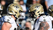 Nov 3, 2024; Charlotte, North Carolina, USA; New Orleans Saints tight end Foster Moreau (87) celebrates with center Connor McGovern (61) after scoring a touchdown in the fourth qarter at Bank of America Stadium.