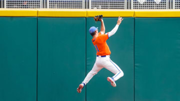 Jun 21, 2023; Omaha, NE, USA; Florida Gators center fielder Michael Robertson (11) makes a catch for the game-winning out to defeat the TCU Horned Frogs at Charles Schwab Field Omaha. Mandatory Credit: Dylan Widger-USA TODAY Sports