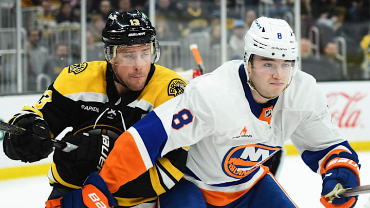 Feb 27, 2025; Boston, Massachusetts, USA; Boston Bruins center Charlie Coyle (13) and New York Islanders defenseman Noah Dobson (8) battle for position during the third period at TD Garden. Mandatory Credit: Bob DeChiara-Imagn Images