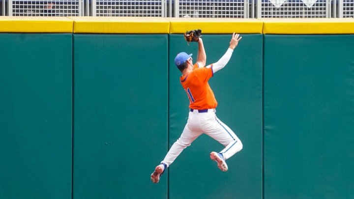 Jun 21, 2023; Omaha, NE, USA; Florida Gators center fielder Michael Robertson (11) makes a catch for the game-winning out to defeat the TCU Horned Frogs at Charles Schwab Field Omaha. Mandatory Credit: Dylan Widger-USA TODAY Sports