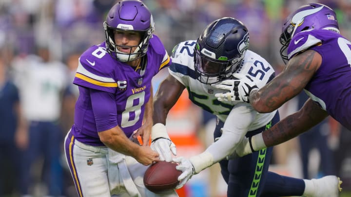 Darrell Taylor strips the ball from former Vikings quarterback Kirk Cousins. Taylor has reportedly been traded to the Bears.