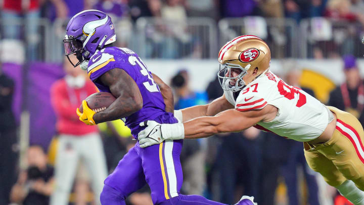 Oct 23, 2023; Minneapolis, Minnesota, USA; Minnesota Vikings running back Cam Akers (31) runs with the ball against the San Francisco 49ers defensive end Nick Bosa (97) in the second quarter at U.S. Bank Stadium.