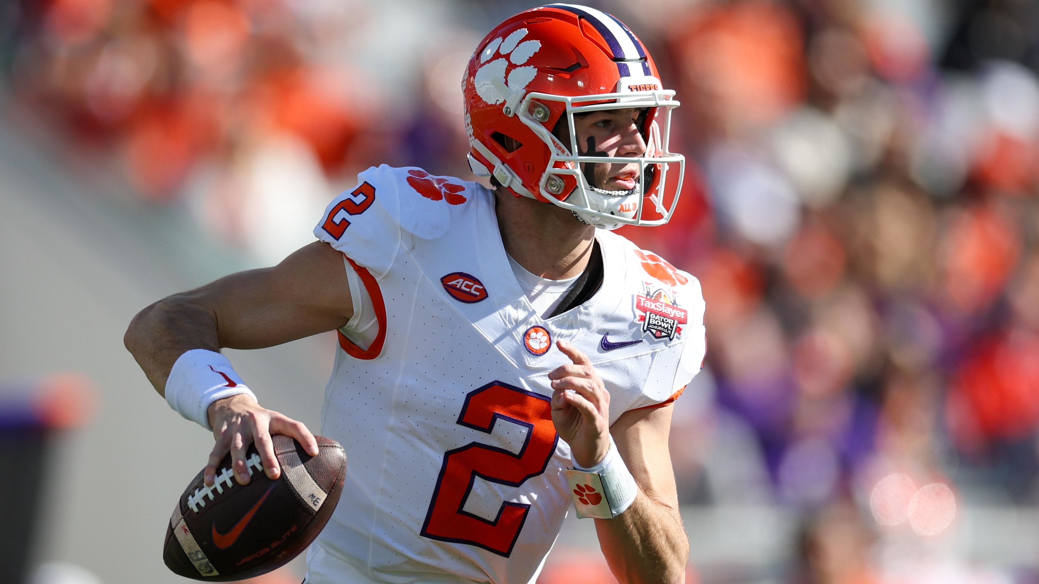Clemson Tigers quarterback Cade Klubnik attempts a pass during a college football game in the ACC.