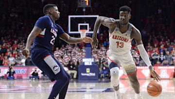 Dec 21, 2017; Tucson, AZ, USA; Arizona Wildcats forward Deandre Ayton (13) dribbles the ball as Connecticut Huskies forward Eric Cobb (23) defends during the second half at McKale Center. Mandatory Credit: Casey Sapio-Imagn Images