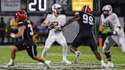 Aug 28, 2025; Orlando, Florida, USA; UCF Knights quarterback Tayven Jackson (2) rolls back to pass as Jacksonville State Gamecocks defensive end Emmanuel Oyebadejo (99) moves in during the second quarter at Acrisure Bounce House. Mandatory Credit: Mike Watters-Imagn Images