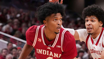 Louisville Cardinals forward Sananda Fru (13) defends Indiana Hoosiers forward Sam Alexis (4) at Gainbridge Fieldhouse in Indianapolis. 