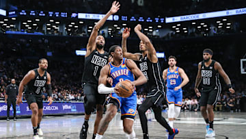 Jan 5, 2024; Brooklyn, New York, USA;  Oklahoma City Thunder forward Jalen Williams (8) is defended by Brooklyn Nets forward Mikal Bridges (1) and center Nic Claxton (33) in the fourth quarter at Barclays Center. Mandatory Credit: Wendell Cruz-USA TODAY Sports