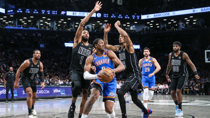 Jan 5, 2024; Brooklyn, New York, USA;  Oklahoma City Thunder forward Jalen Williams (8) is defended by Brooklyn Nets forward Mikal Bridges (1) and center Nic Claxton (33) in the fourth quarter at Barclays Center. Mandatory Credit: Wendell Cruz-USA TODAY Sports