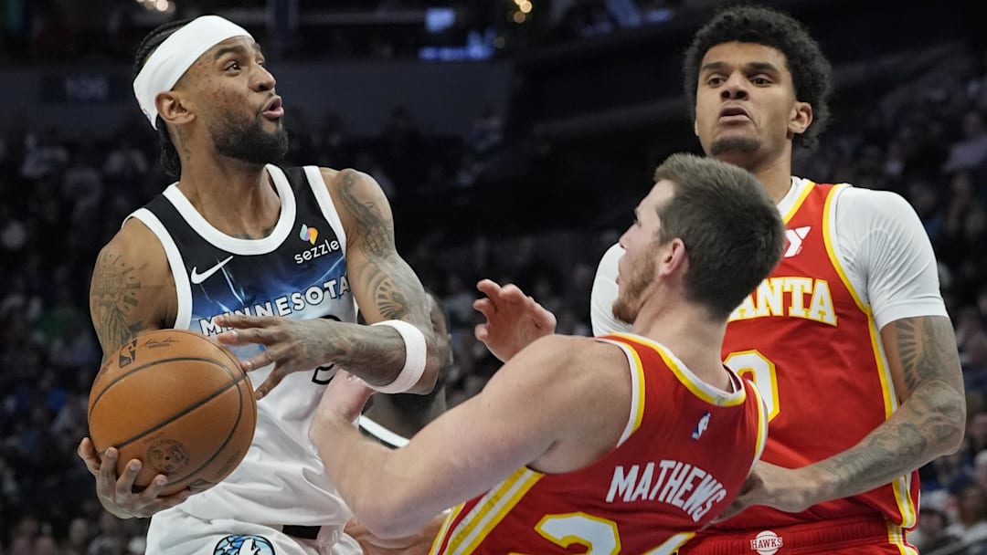 Minnesota Timberwolves forward Nickeil Alexander-Walker (9) charges into Atlanta Hawks forward Garrison Mathews (24) in the third quarter at Target Center.
