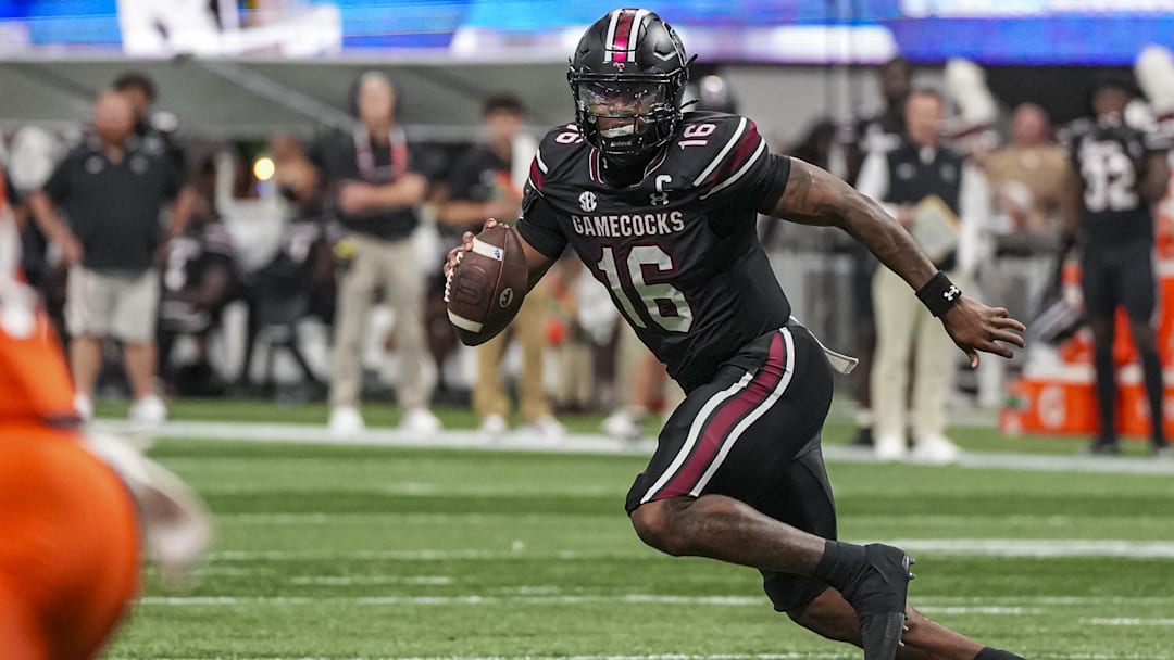 Aug 31, 2025; Atlanta, Georgia, USA; South Carolina Gamecocks quarterback LaNorris Sellers (16) rolls out of the pocket against the Virginia Tech Hokies during the first half at Mercedes-Benz Stadium. Mandatory Credit: Dale Zanine-Imagn Images
