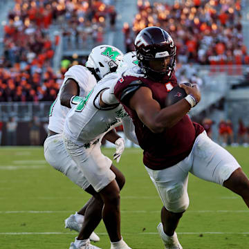 Sep 7, 2024; Blacksburg, Virginia, USA; Virginia Tech Hokies quarterback Kyron Drones (1) run for a touchdown during the third quarter against Marshall Thundering Herd cornerback Jacobie Henderson (10) at Lane Stadium. Mandatory Credit: Peter Casey-Imagn Images