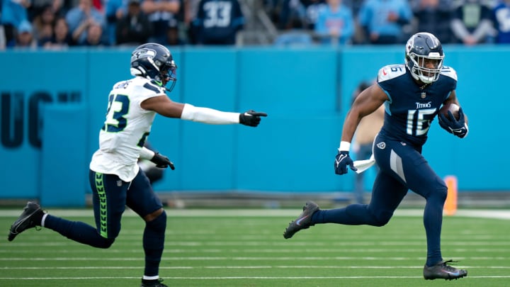 Tennessee Titans wide receiver Treylon Burks (16) runs after the catch as Seattle Seahawks safety Jamal Adams (33) pursues late in the fourth quarter of their game at Nissan Stadium in Nashville, Tenn., Sunday, Dec. 24, 2023.