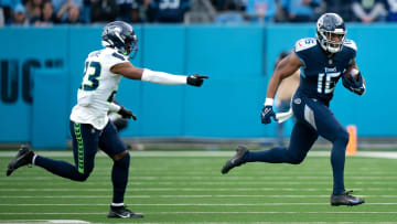 Tennessee Titans wide receiver Treylon Burks (16) runs after the catch as Seattle Seahawks safety Jamal Adams (33) pursues late in the fourth quarter of their game at Nissan Stadium.