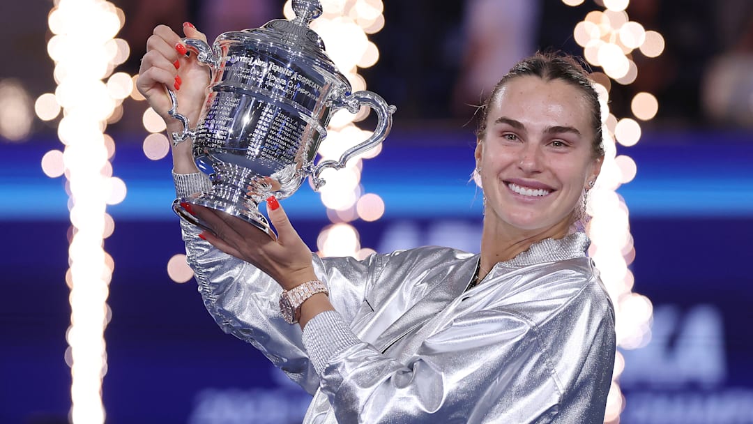 Aryna Sabalenka holds aloft the U.S. Open trophy after the tournament final.