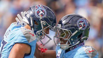 Tennessee Titans wide receiver Chimere Dike (17) celebrates his touchdown with running back Tony Pollard (20) during the first quarter against the New England Patriots at Nissan Stadium in Nashville, Tenn., Sunday, Oct. 19, 2025.