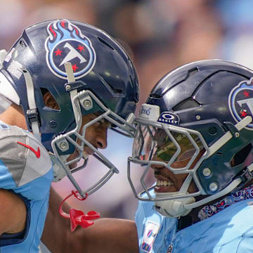 Tennessee Titans wide receiver Chimere Dike (17) celebrates his touchdown with running back Tony Pollard (20) during the first quarter against the New England Patriots at Nissan Stadium in Nashville, Tenn., Sunday, Oct. 19, 2025.