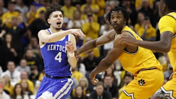 Mar 8, 2025; Columbia, Missouri, USA; Kentucky Wildcats guard Koby Brea (4) passes the ball as Missouri Tigers center Josh Gray (33) defends in the second half at Mizzou Arena. Mandatory Credit: Gary Rohman-Imagn Images