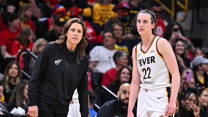 Indiana Fever guard Caitlin Clark (22) looks on with head coach Stephanie White during the third quarter against the Brazil National Team at Carver-Haweye Arena. Indiana Fever guard Caitlin Clark (22) looks on with head coach Stephanie White during the third quarter against the Brazil National Team at Carver-Haweye Arena.