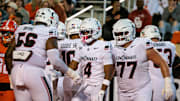 Oct 18, 2025; Stillwater, Oklahoma, USA; Cincinnati Bearcats wide receiver Cyrus Allen (4) celebrates in the end zone after scoring a touchdown during the first half against the Oklahoma State Cowboys at Boone Pickens Stadium. Mandatory Credit: William Purnell-Imagn Images