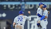 Los Angeles Dodgers second baseman Miguel Rojas (72) and shortstop Mookie Betts (50) and first baseman Enrique Hernandez (8) celebrate after defeating the Toronto Blue Jays during game six of the 2025 MLB World Series at Rogers Centre on Friday.