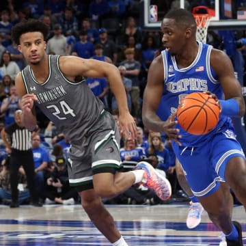 Mar 3, 2024; Memphis, Tennessee, USA; Memphis Tigers forward David Jones (8) dribbles up the court as UAB Blazers guard Efrem Johnson (24) defends during the first half at FedExForum. Mandatory Credit: Petre Thomas-USA TODAY Sports