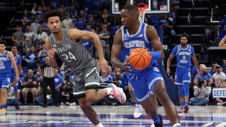 Mar 3, 2024; Memphis, Tennessee, USA; Memphis Tigers forward David Jones (8) dribbles up the court as UAB Blazers guard Efrem Johnson (24) defends during the first half at FedExForum. Mandatory Credit: Petre Thomas-USA TODAY Sports