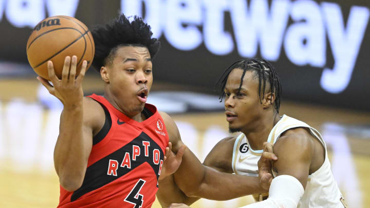 Dec 23, 2022; Cleveland, Ohio, USA; Toronto Raptors forward Scottie Barnes (4) drives against Cleveland Cavaliers forward Isaac Okoro (35) in the first quarter at Rocket Mortgage FieldHouse. Mandatory Credit: David Richard-USA TODAY Sports