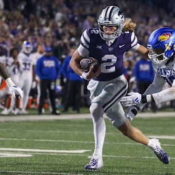 Oct 26, 2024; Manhattan, Kansas, USA; Kansas State Wildcats quarterback Avery Johnson (2) runs by Kansas Jayhawks defensive end Jereme Robinson (90) on his way to a touchdown in the fourth quarter at Bill Snyder Family Football Stadium. Mandatory Credit: Scott Sewell-Imagn Images