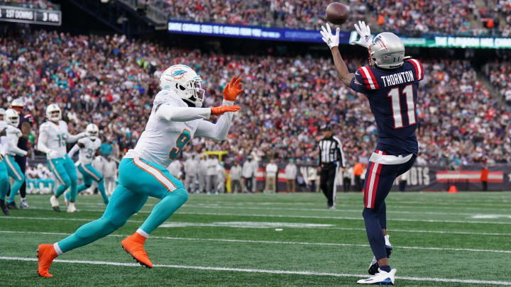 Jan 1, 2023; Foxborough, Massachusetts, USA; New England Patriots wide receiver Tyquan Thornton (11) makes the touchdown against Miami Dolphins cornerback Noah Igbinoghene (9) in the first quarter at Gillette Stadium. Mandatory Credit: David Butler II-USA TODAY Sports
