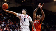 Dec 15, 2024; Blacksburg, Virginia, USA; Navy Midshipmen forward Donovan Draper (11) shoots the ball against Virginia Tech Hokies forward Tobi Lawal (1) during the second half at Cassell Coliseum. 