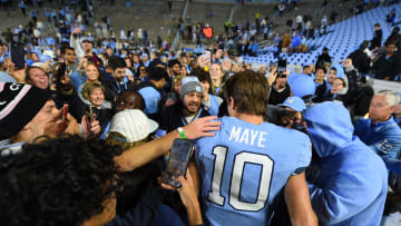 Nov 11, 2023; Chapel Hill, North Carolina, USA; Fans with North Carolina Tar Heels quarterback Drake