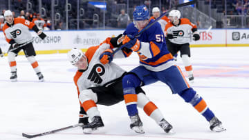 Sep 27, 2023; Elmont, New York, USA; New York Islanders left wing Eetu Liukas (57) and Philadelphia Flyers defenseman Emil Andrae (36) fight for the puck during the second period at UBS Arena. Mandatory Credit: Brad Penner-USA TODAY Sports