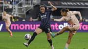 May 18, 2024; Washington, District of Columbia, USA; Angel City FC midfielder Lily Nabet (28) takes a shot on goal as Washington Spirit midfielder Hal Hershfelt (17) defends during the first half at Audi Field. 