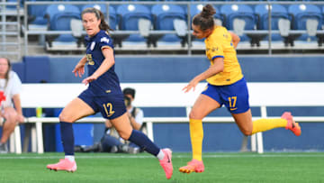 Jul 7, 2024; Seattle, Washington, USA; Seattle Reign FC midfielder Olivia Athens (12) controls the ball as Utah Royals FC defender Ana Tejada (17) defends during the second half at Lumen Field. Mandatory Credit: Steven Bisig-USA TODAY Sports