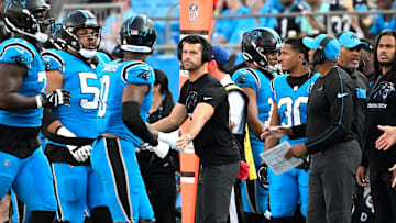 Oct 13, 2024; Charlotte, North Carolina, USA;  Carolina Panthers head coach Dave Canales high-fives players in the second quarter at Bank of America Stadium. Mandatory Credit: Bob Donnan-Imagn Images