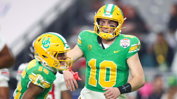 Oregon Ducks quarterback Bo Nix (10) celebrates a touchdown with  wide receiver Tez Johnson (15) during the second half again
