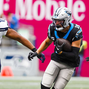 Sep 24, 2023; Seattle, Washington, USA; Carolina Panthers wide receiver Adam Thielen (19) runs for yards after the catch against Seattle Seahawks linebacker Uchenna Nwosu (10) during the first quarter at Lumen Field. Mandatory Credit: Joe Nicholson-Imagn Images