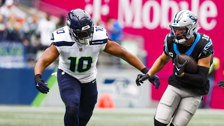 Sep 24, 2023; Seattle, Washington, USA; Carolina Panthers wide receiver Adam Thielen (19) runs for yards after the catch against Seattle Seahawks linebacker Uchenna Nwosu (10) during the first quarter at Lumen Field. Mandatory Credit: Joe Nicholson-Imagn Images