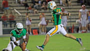 DeLand's Cristian  Baez (22) kicks one of his two field goals to lead the Bulldogs past Lake Gibson, 54-7, on Halloween night.