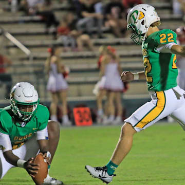 DeLand's Cristian  Baez (22) kicks one of his two field goals to lead the Bulldogs past Lake Gibson, 54-7, on Halloween night.